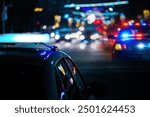 Police cars at night. Police car chasing a car at night. 911 Emergency response police car speeding to scene of crime. Selective focus on cars