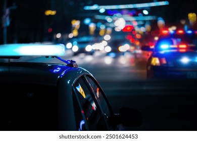 Police cars at night. Police car chasing a car at night. 911 Emergency response police car speeding to scene of crime. Selective focus on cars