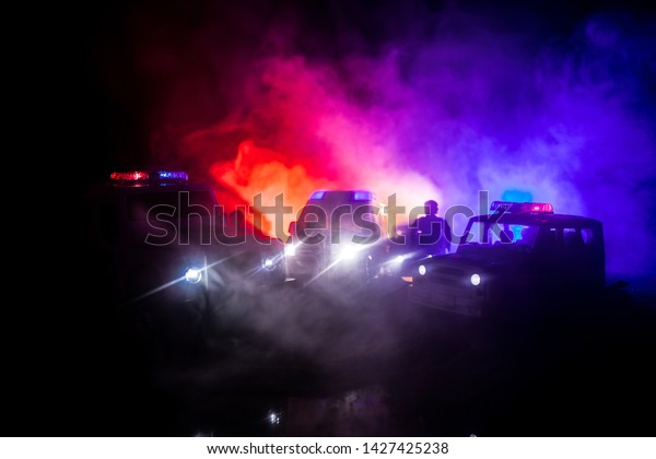 Police cars at night. Police car
chasing a car at night with fog background. 911 Emergency response
police car speeding to scene of crime. Selective
focus