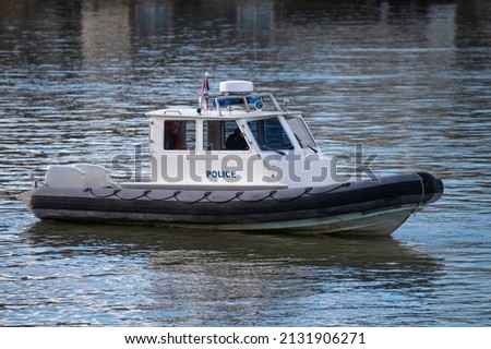 Police coast guard motor boat on water surface. Police patrol boat on the River in action. Emergency response