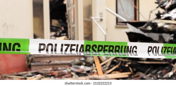 A Police Cordon At A Burned Down House 