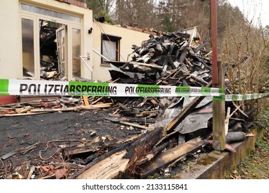 A Police Cordon At A Burned Down House 