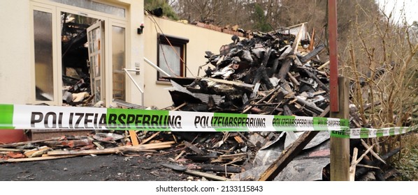 A Police Cordon At A Burned Down House 