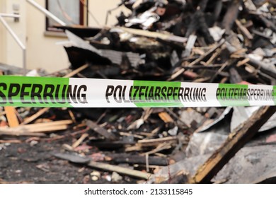 A Police Cordon At A Burned Down House 