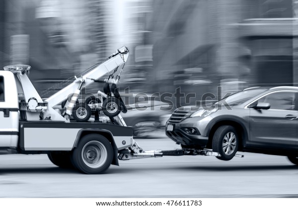 police\
department tow truck delivers the damaged\
vehicle