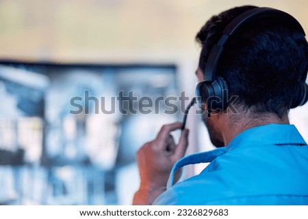 Police dispatch, communication headset and man talking, speaking and consulting with security, monitor CCTV or callcenter. Conversation, support consultation and back of person chat about 911 service ストックフォト © 