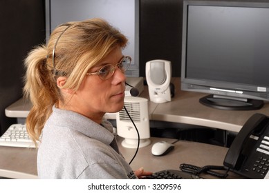 Police Dispatcher Sitting At A Dispatch Console