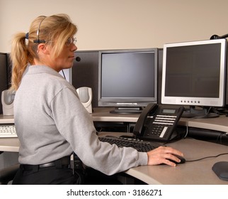 A Police Dispatcher Working At Console