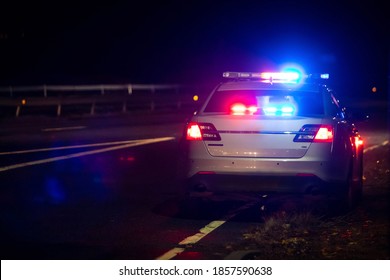 Police emergency flash lights at night from the back on highway