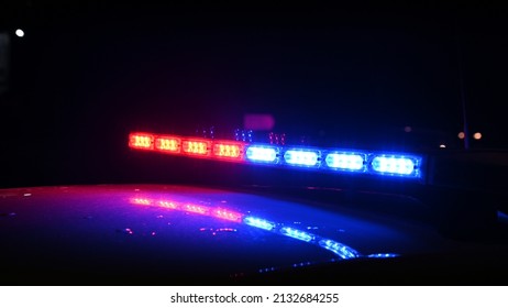 Police Emergency Lights Flash At Night. Car Accident. Crime Scene.  Flashing Blue And Red Lights On Patrol Car. 