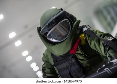 The police in The explosive ordnance disposal suit (BOMB Suit) working in the indoor of airport terminal, to find the bomb.