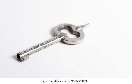 A Police Handcuff Key Isolated On A White Background. Key To Freedom Concept.