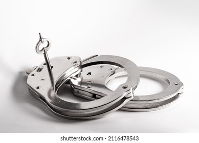Police Handcuffs. Equipment For Police Officers. Opening Handcuffs With A Key. Symbol Of Justice And Catching Criminals.
