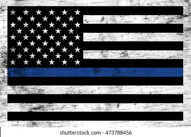 A police and law enforcement support flag stained over a weathered white wooden background.