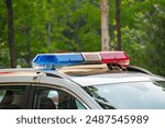 Police lights on car during traffic surveillance on the city road. Flash light on the vehicle of the Emergency Services. Red and blue flashes on the cars of the Patrol specialized unity. 