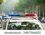 Police lights on car during traffic surveillance on the city road. Flash light on the vehicle of the Emergency Services. Red and blue flashes on the cars of the Patrol specialized unity. 