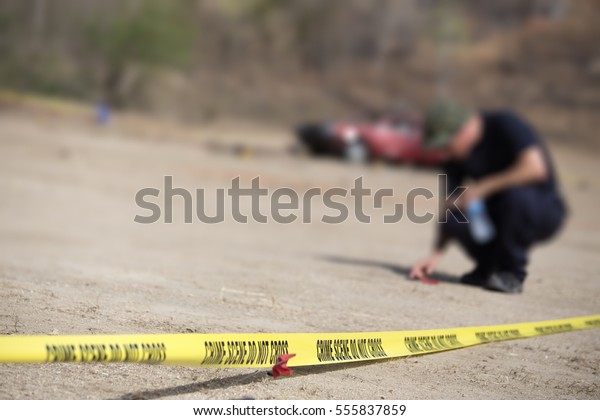 police\
line do no cross with blurred law enforcement searching background\
in car bomb investigation training with copy\
space