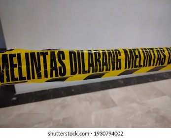 police line do not cross or "dilarang melintas" in indonesia language.
