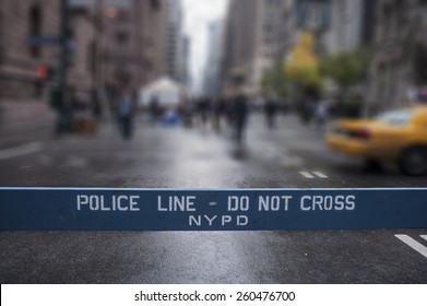 Police Line Do Not Cross. A Police Line Do Not Cross Police Department Crime Scene Sign On The Sidewalk In New York City. Blur Background.