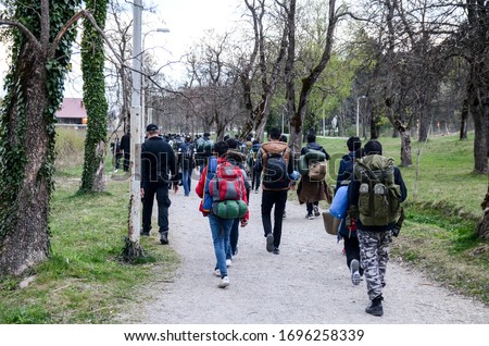 Police and migrants walking in Bihac, BiH. Bosnia and Herzegovina struggles with thousands of refugees on new route to European Union. Balkan Route. 