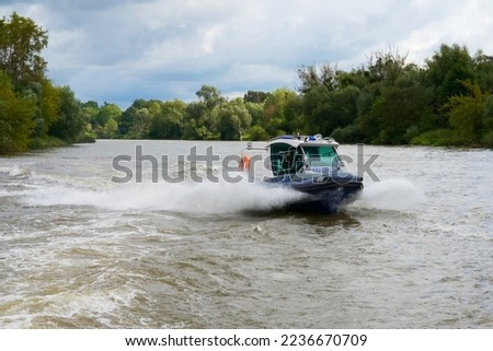 police motorboat chasing the ship on the river