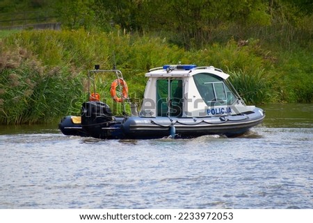 police motorboat patrolling the river surroundings
