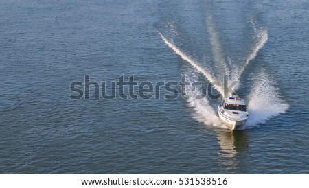 police motorboat with waves on the river Danube