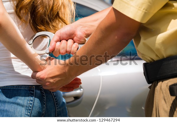 Police officer
arresting a woman with
handcuffs