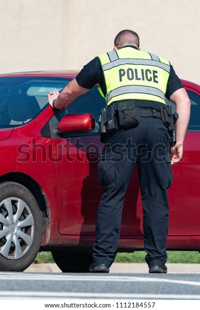 Police officer\
conducting a traffic\
stop