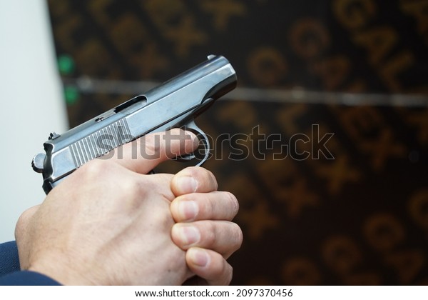 A police\
officer demonstrates a service\
weapon