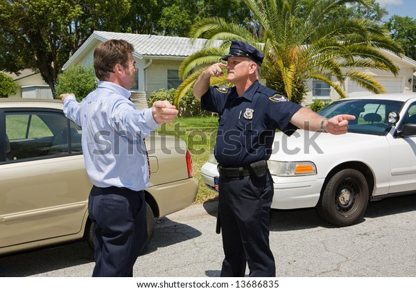 Police officer demonstrating a field sobriety\
test to a motorist.