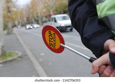 Police Officer Is Doing A Traffic Check And Looks At The Documents. Speed Control And Alcohol Testing.