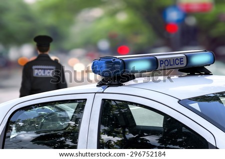 Police officer emergency service car driving street with siren light blinking 