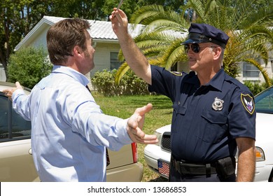 Police Officer Giving A Field Sobriety Test To A Drunk Driver.