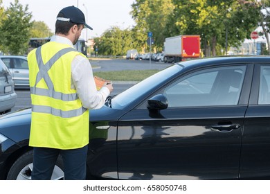 Police officer giving a ticket fine for parking violation