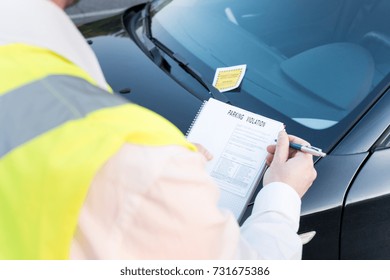 Police officer giving a ticket fine for parking violation
