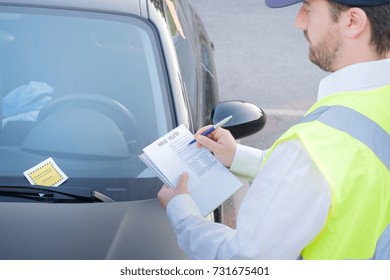 Police Officer Giving A Ticket Fine For Parking Violation