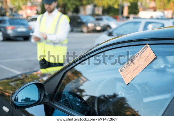 Police\
officer giving a ticket fine for parking\
violation