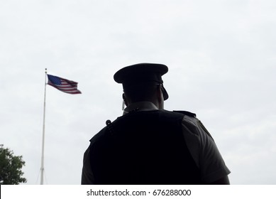 Police Officer / Guard In Front Of American Flag