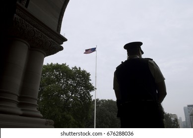 Police Officer / Guard In Front Of American Flag