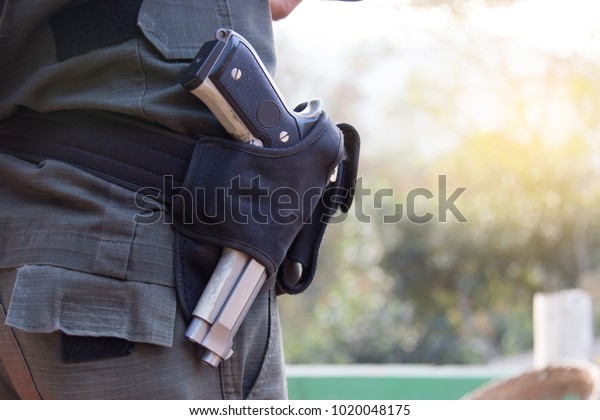Police officer with gun\
belt.