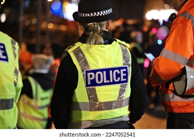 Police officer in hi-visibility jacket policing crowd control at an outside UK event - Shutterstock ID 2247052541