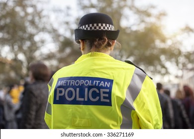 Police Officer In Hi-visibility Jacket Policing Crowd Control At A UK Event