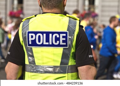 Police Officer In Hi-visibility Jacket With Text Police Written