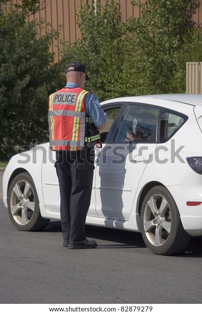 Police officer issuing\
speeding ticket