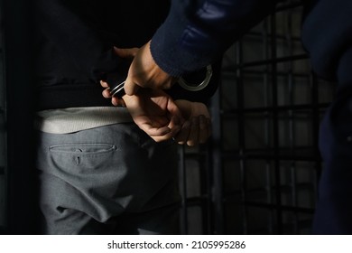  A Police Officer Leads A Detained Person To The Department