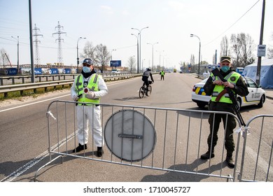 Police Officer And Member Of Ukrainian National Guard Is Stand At A Checkpoint During The Coronavirus Disease COVID-19 Outbreak On The Outskirts Of Kyiv, Ukraine April 18, 2020