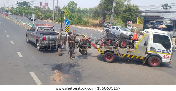 Police officer moving a\
Motorcycle after got clash. Taken on Mukdahan Province , 6 April\
2021