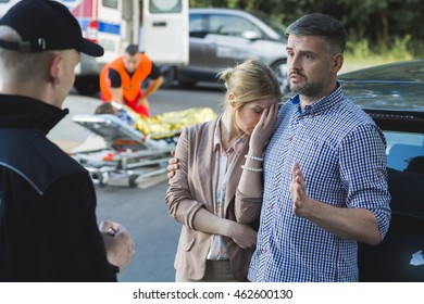 Police Officer Noting Down The Testimony Of Accident Onlookers