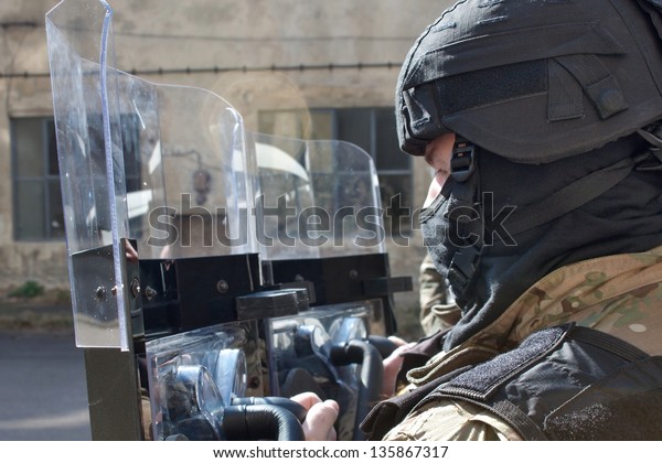 police officer in a protective helmet and\
visor, preparation for the\
demonstration